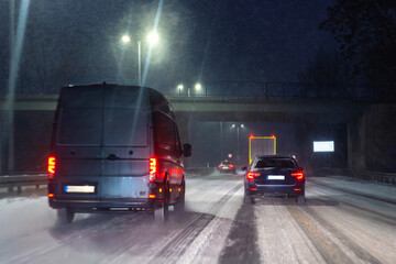Winter traffic jam on snowy highway road night with long queue car, glowing red taillights, icy asphalt, falling snow, poor visibility and stressful commute conditions. Cold city transport atmosphere