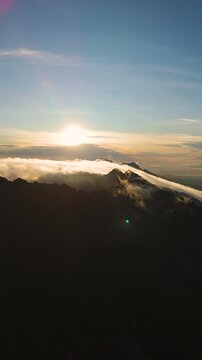 4K drone footage of Mount Raung at sunrise, revealing steep ridges, misty forests, and one of Indonesia&rsquo;s most extreme hiking trails with cloud and vulcano 