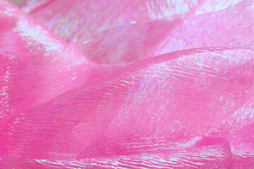 Soft waves of delicate pink fabric background.