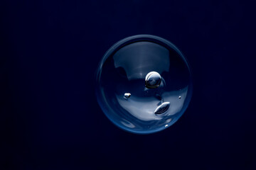 Clear bubble reflecting light against dark background