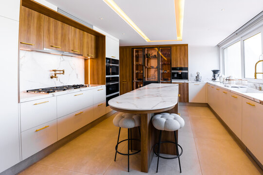 Contemporary luxury kitchen with marble island and wood accents