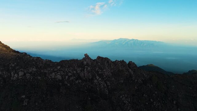 4K drone footage of Mount Raung at sunrise, revealing steep ridges, misty forests, and one of Indonesia&rsquo;s most extreme hiking trails with cloud and vulcano 