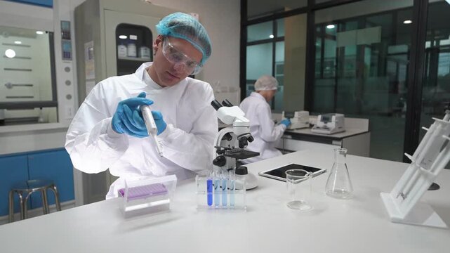 Researcher works in lab with microscope and tools for science experiment