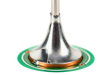 Macro view of metal component soldered onto green electronic circuit board isolated with transparent background