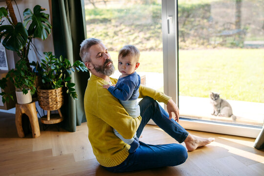 Father with little toddler son at home.