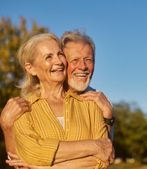 Happy active senior couple having fun in park outdoors