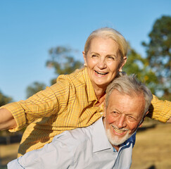Happy active senior couple having fun outdoors. Portrait of an elderly couple together