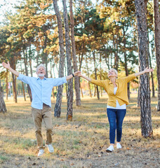 Happy active senior couple meditating and daydreaming and relaxing and nature outdoors