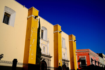Weathered Yellow Facade Under Deep Blue Sky (Puebla, Mexico)
