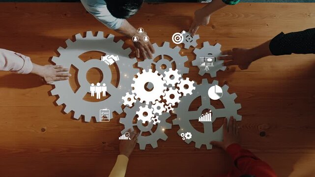 A diverse group of individuals collaborates over a wooden table, interacting with symbolic gears and icons that represent teamwork, strategy, and business growth. Raster