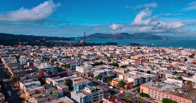Picturesque urban landscape on sunny daytime. Approaching the waterfront of beautiful San Francisco Bay with the Golden Gate Bridge at backdrop.
