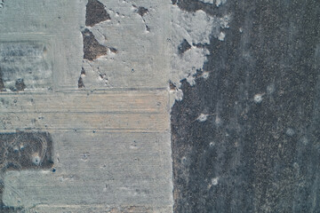 Abstract geometric field pattern with textured soil contrast and frost details featuring agricultural minimalist landscape aerial top down view