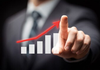 Businessman touching rising chart with red arrow. Concept of business growth, profit, financial success, analytics, sales increase, investment and positive performance
