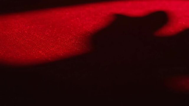Abstract red shapes and shadows on textured surface