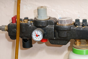 Pressure gauge and valve system in a workshop setting for monitoring gas flow and pressure levels