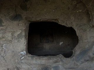 Prehistoric nuraghe stone structure rising from green landscape under dramatic sky in Sardinia