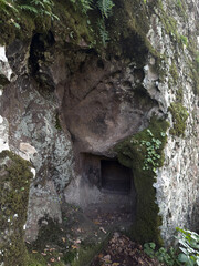 Prehistoric nuraghe stone structure rising from green landscape under dramatic sky in Sardinia