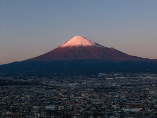 Aerial view of Mount Fuji and Fuji City at dusk, Shizuoka, Japan