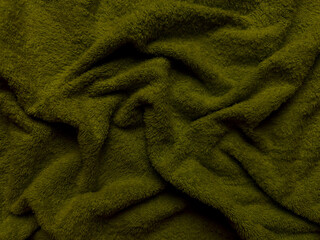 lush olive green fluffy fabric texture folds gracefully in macro view evoking cozy warmth ideal for seasonal wallpaper or apparel design background © Arthur