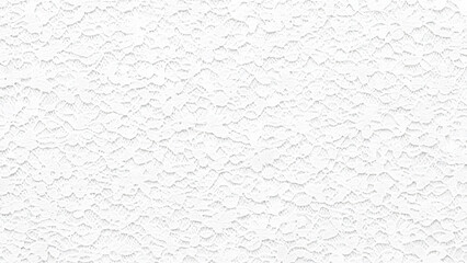 A closeup view of a white stucco wall texture with a rough surface