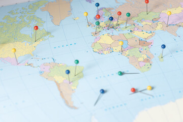 World map with colorful pushpins showing locations for global travel and planning