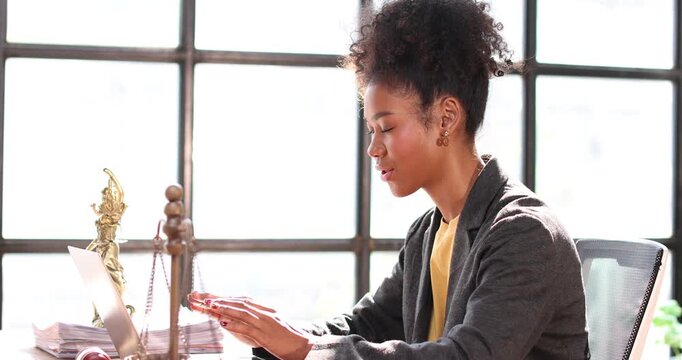 African American Lawyer woman afro hair with phone call, documents and reading thinking for crime analysis. Advocate, lawyer or judge with legal research, paperwork and networking for court evidence
