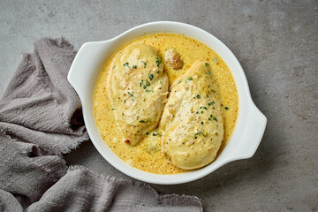 delicious chicken breast meat with creamy sauce in white bowl