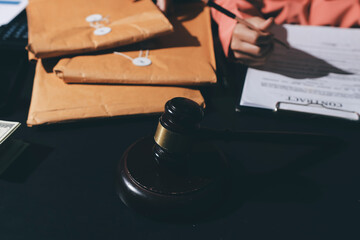 Consultation and conference of professional businesswoman and Male lawyers working and discussion having at law firm in office. Concepts of law, Judge gavel with scales of justice