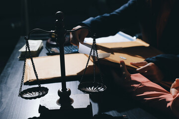 Consultation and conference of professional businesswoman and Male lawyers working and discussion having at law firm in office. Concepts of law, Judge gavel with scales of justice