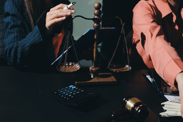 Consultation and conference of professional businesswoman and Male lawyers working and discussion having at law firm in office. Concepts of law, Judge gavel with scales of justice