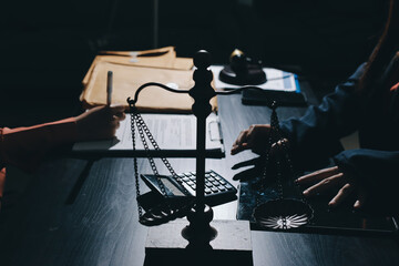 Consultation and conference of professional businesswoman and Male lawyers working and discussion having at law firm in office. Concepts of law, Judge gavel with scales of justice