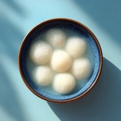 Traditional Korean rice cake soup tteokguk in blue ceramic bowl symbolizes celebration and renewal, often served during Lunar New Year and festive gatherings