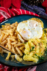 Fried eggs with boiled potatoes and yellow string beans.