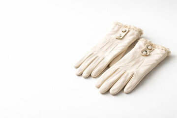 A pair of vintage white lace gloves. Space for text.