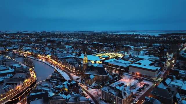 Snowy winter sunset over a historic maritime town