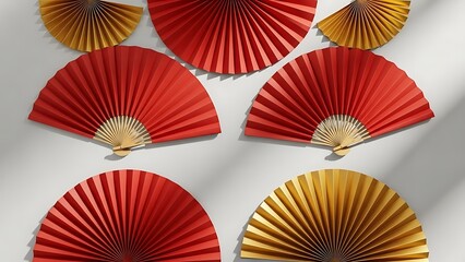 A collection of traditional Japanese folding fans in red and gold colors arranged on a plain surface creating a festive and vibrant display