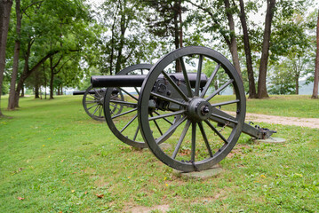 Historic cannons displayed on grassy field at preserved battlefield in Virginia