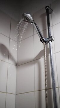 Inspector Detects Ongoing Water Seepage, Constant Dripping Observed In Bathroom Corner During Night, Persistent Water Drip From Bathroom Corner Shower During Nighttime Hours Observed By Inspector