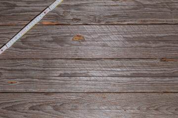 Folding Ruler in Upper Left Corner on Weathered Wood
