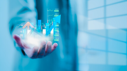 Businessman holding virtual financial graph with upward trend, stock market data, and investment growth indicators symbolizing digital finance and economic success. finance, investment, stock, growth