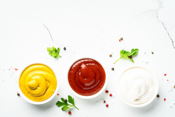 Sauce bowls - mayonnaise, mustard, ketchup on white background.