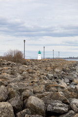 Prescott rocky waterfront and lighthouse on St. Lawrence River in Ontario, Canada. Small lighthouse.