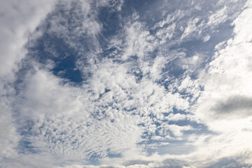 White clouds across bright blue sky.