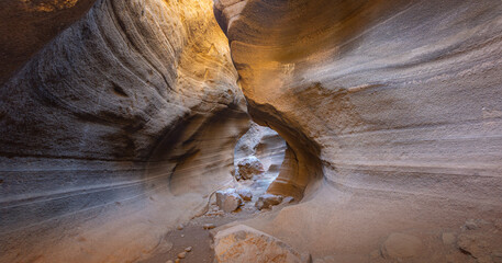 Desert slot canyon Barranco de las vacas showing narrow sedimentary rock walls