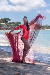 Woman Wearing Red Bikini and Dress on a tropical beach. Remote tropical beach