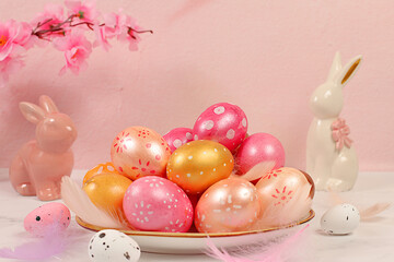 Beautiful Easter banner with decorated festive eggs, sakura and cherry blossom branches, rabbits and feathers. Happy Easter concept. An abstract spring Easter composition with space for text