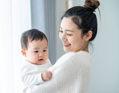 A happy mother bonding with her baby, daughter, and son while sharing a tender moment of love and connection during a joyful family day