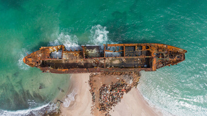 Aerial View of Rusted Shipwreck on Beach