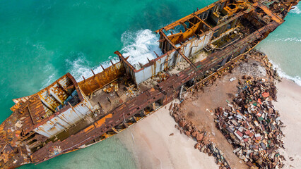 Aerial View of Rusted Shipwreck on Sandy Beach