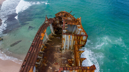 Rusted Shipwreck on Sandy Beach